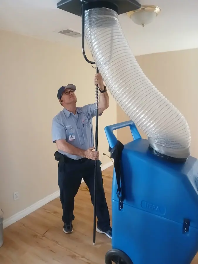 Furnace Tune-Up technician using HEPA equipment in Novi